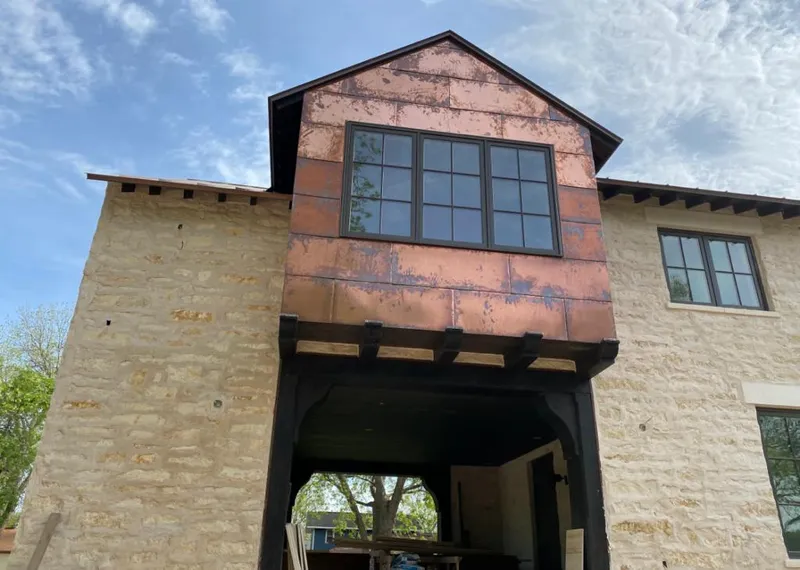 Copper metal panel facade on a stone building for Roof Repair in Western Springs