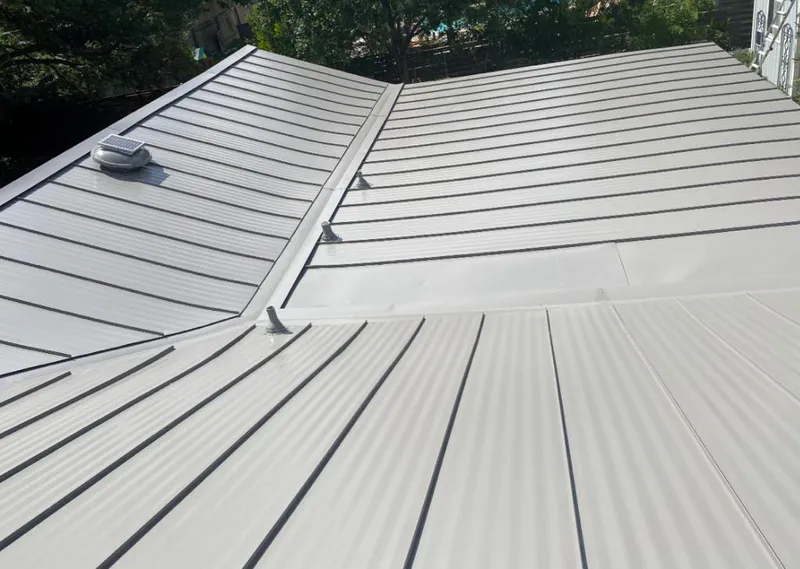 Solar attic fan installed on a metal roof for Roof Ventilation in Western Springs
